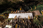 Luang Prabang, Laos - The Pak Ou Caves, the lower cave called Tham Ting. The caves, a Buddhist pilgrimage site, are a repository of old Buddha statues. 